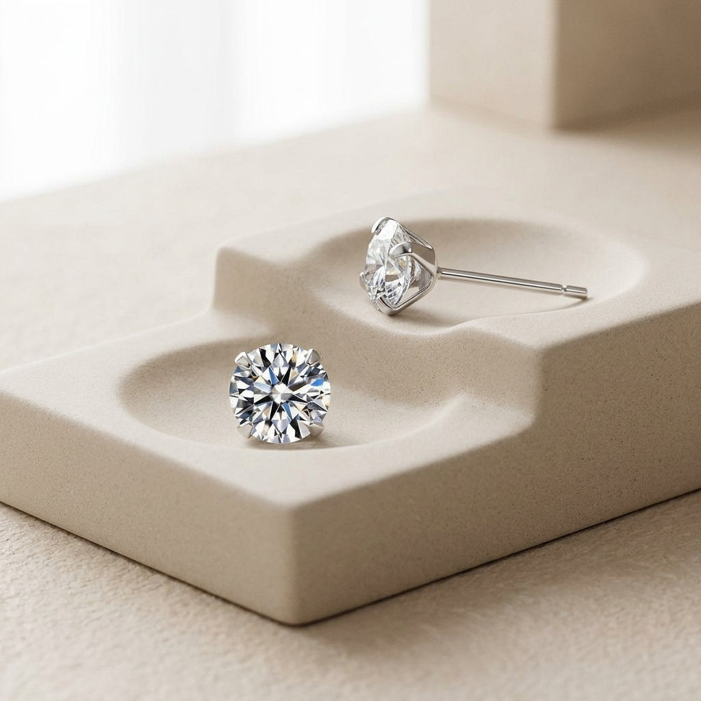 Pair of silver-tone 4 mm moissanite stud earrings shown at wearable scale